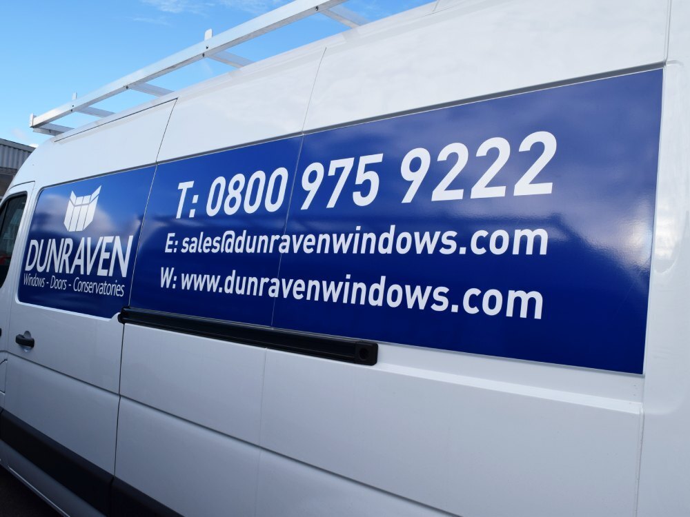 Branded blue company vinyl graphics on white Renault Master van.