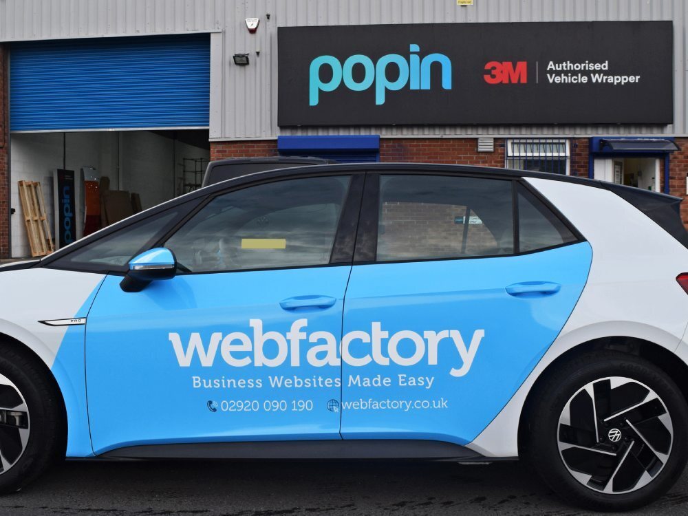 Partial branded vehicle wrap on Volkswagen ID3 company car outside Popin in Cardiff.