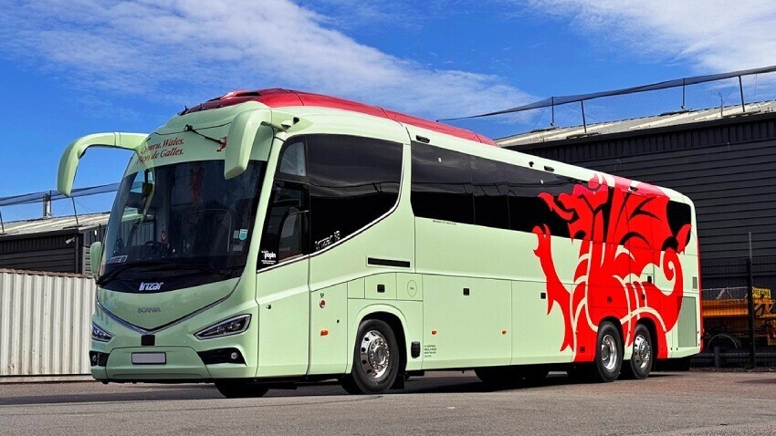 Scania Irizar coach with FAW branded green livery and red Welsh dragon design vinyl graphics.