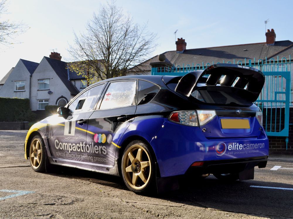 Bold and vibrant motorsport wrap and decals on a Subaru Impreza B13 rally car