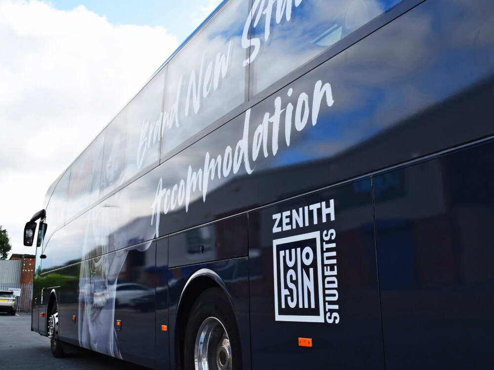 White vinyl graphics with Zenith Students company branding installed on side of Mercedes Tourismo coach.