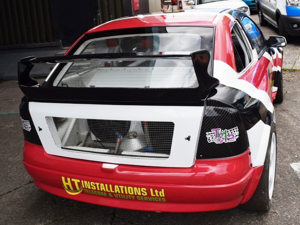 Vehicle wrap and branded vinyl graphics on rear of Vauxhall Astra company car.