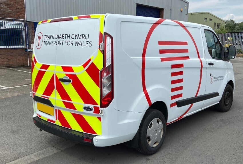 Reflective safety markings on a white van.