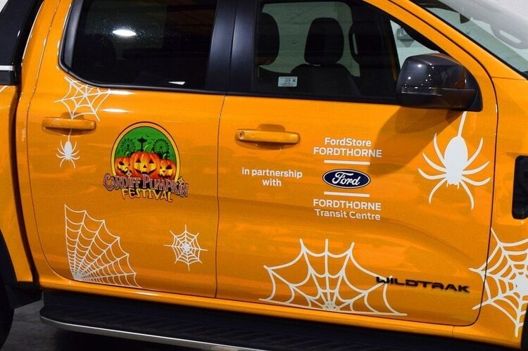 Temporary seasonal Halloween promotional vinyl graphics on Ford pick-up truck.
