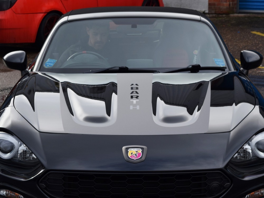 Black motorsport livery installed on a Abarth 124 Spider sports car