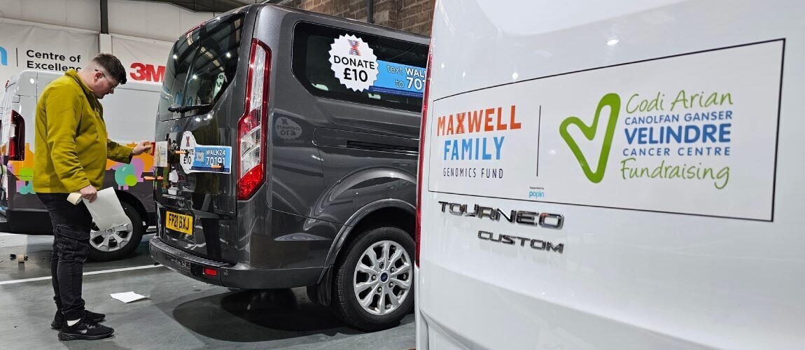 Professional installer applying vinyl graphics to a commercial vehicle.