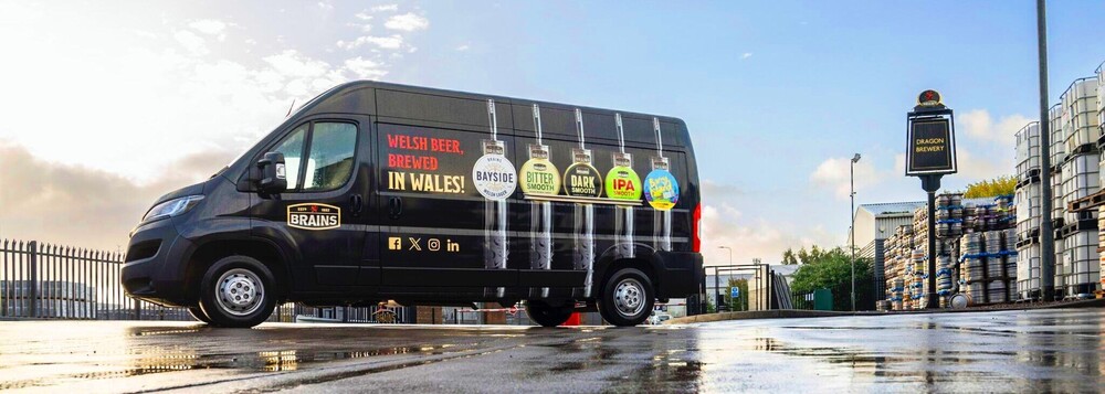 Vehicle graphics on commercial van performing in UK weather conditions.