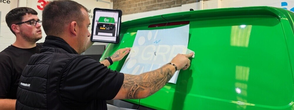Installing fresh vinyl graphics on a commercial van.