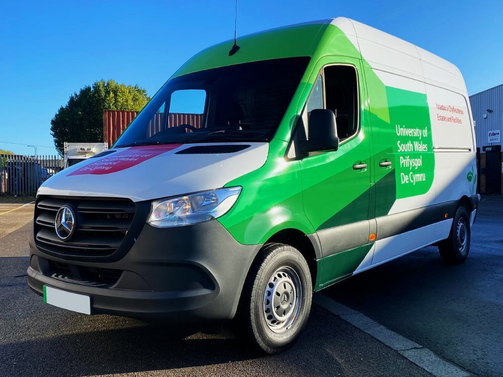 Mercedes-Benz eSprinter with green livery and University of South Wales vinyl graphics.