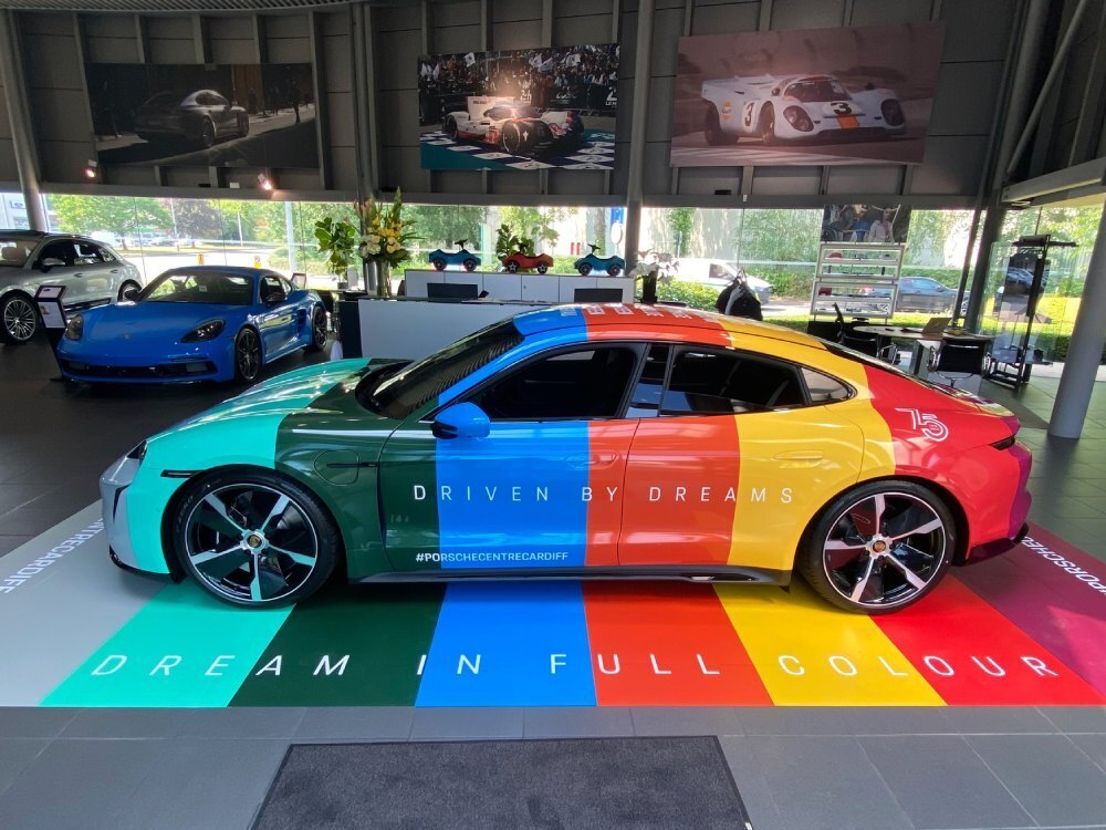 Porsche Taycan Turbo in Cardiff showroom with 75th anniversary motorsport wrap