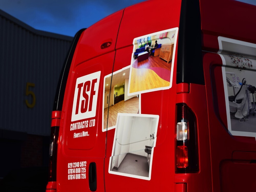 Bold red business branded van wrap with imagery on Nissan Primastar.