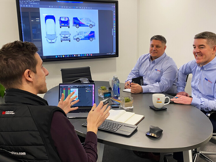 Vehicle wrap designers in Popin meeting room 