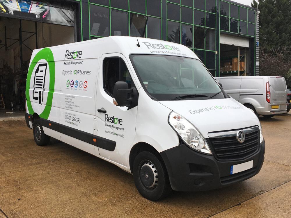 White Vauxhall Movano van with vehicle vinyl graphics.
