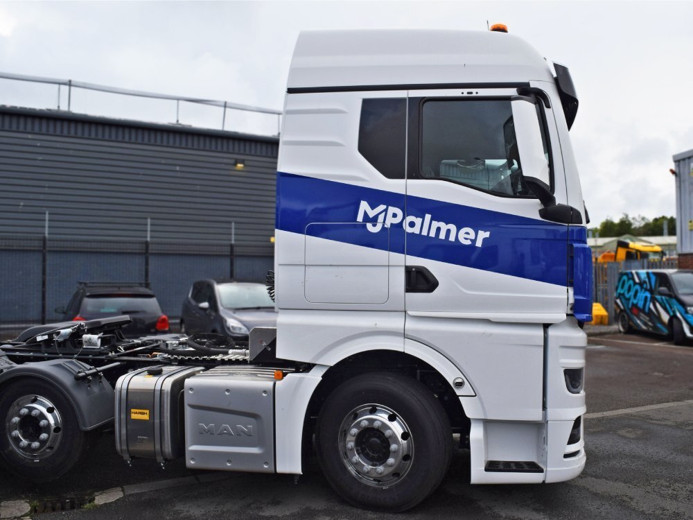 White and blue livery installed on a MAN lorry cab.