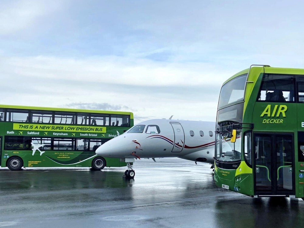Matching green Bath Bus Company branded vehicle wraps on two Volvo EvoSeti Air Decker buses.