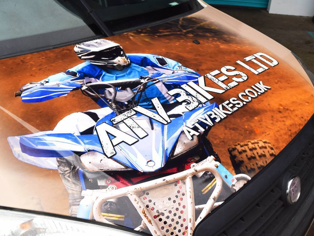 Close up details of a vehicle wrap on a Fiat Doblo Cargo company van.