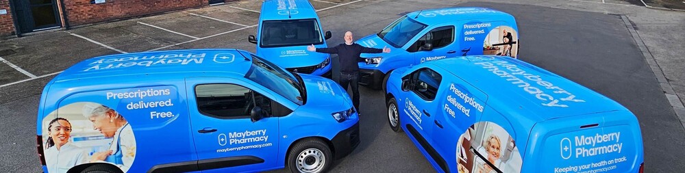 Happy business owner with newly wrapped fleet of company branded vans.