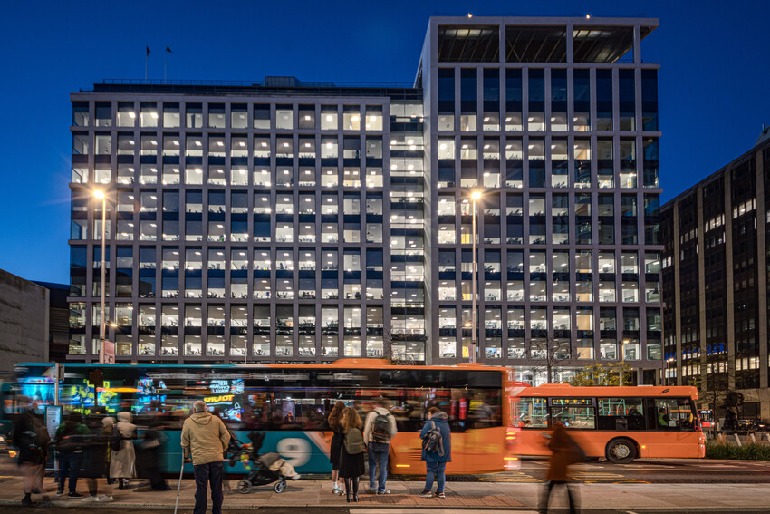 Cardiff city centre at night with vehicles driving passed