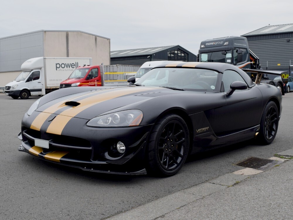Matte black motorsport livery with two gold sport stripe graphics on Dodge Viper SRT10