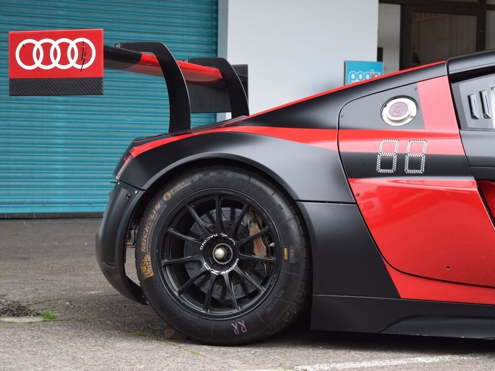 Rear wheel of Audi R8 with custom red and black car graphics