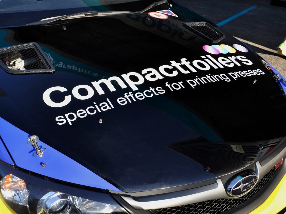 Commercial vinyl decals on bonnet of a Subaru Impreza B13 rally car