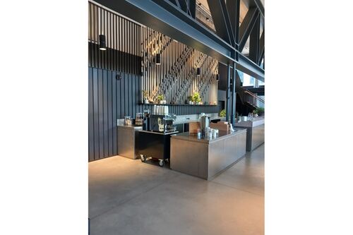 Mobile coffee cart with espresso machine and self-serve tea station inside Dock Shed.