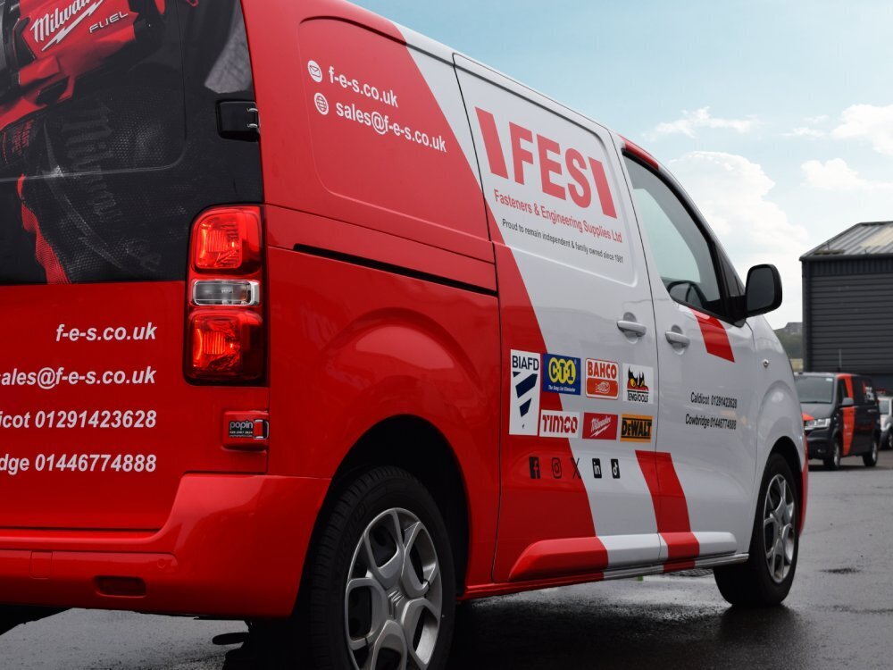 Red and white vehicle wrap and graphics on a Citroen Dispatch company van.