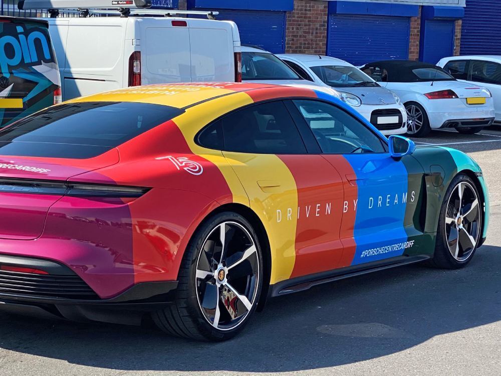 Colourful full company vehicle wrap on Porsche Taycan Turbo.