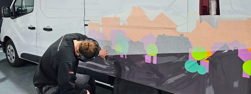 Vinyl graphics being installed on company van at Popin wrap centre in Cardiff.