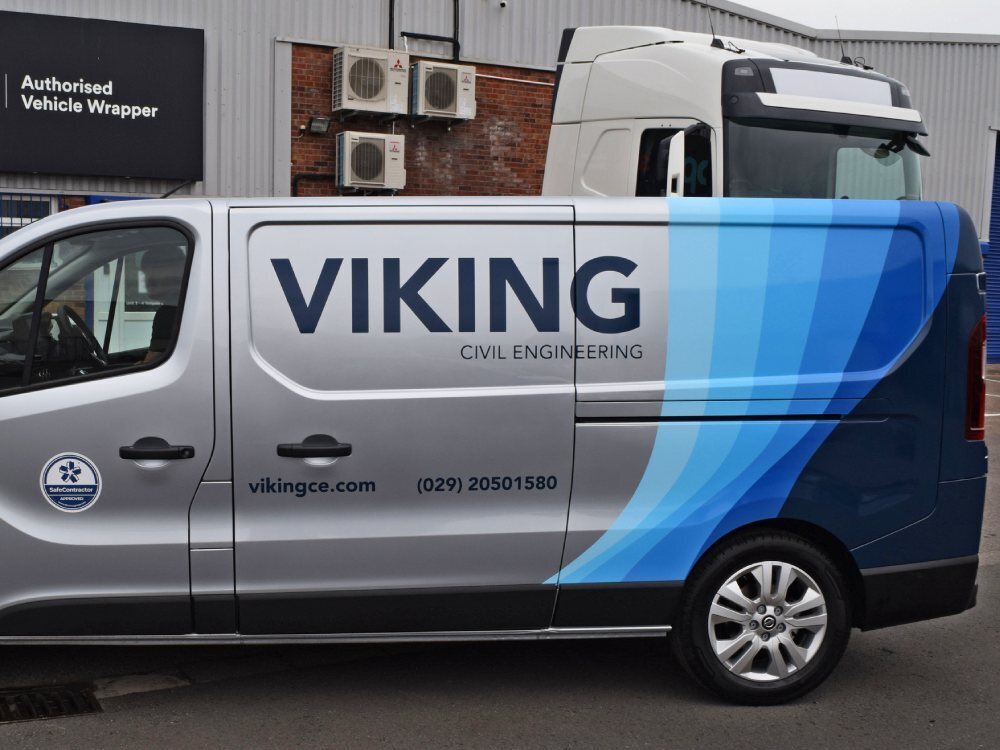 Silver Nissan NV300 with business branded partial van wrap.
