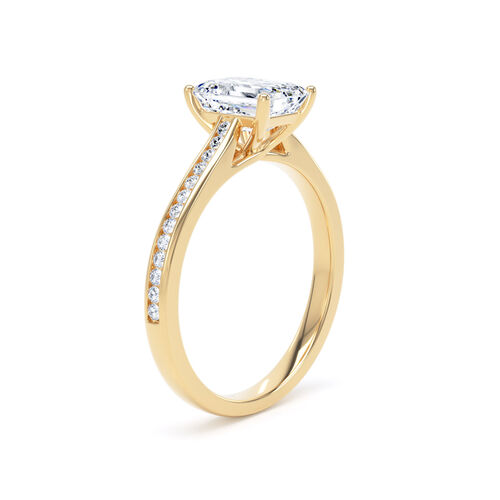 Emerald cut solitaire with channel set diamond shoulders