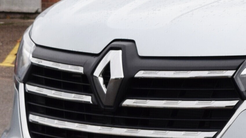 Renault emblem on the front of a silver van.