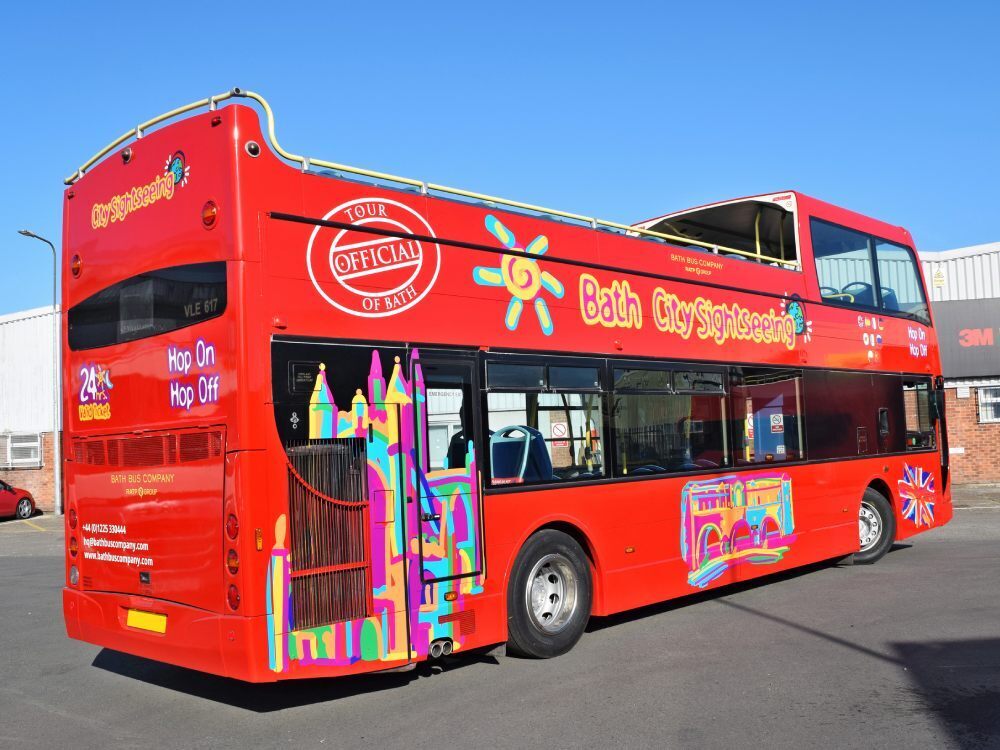 Red Optare VLE open top tour bus with Tootbus Bath City Sightseeing promotional vinyl graphics.