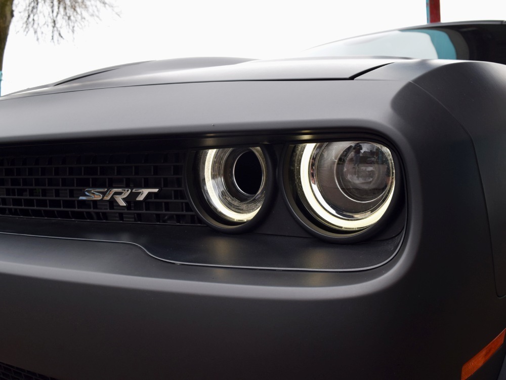 Matte black motorsport livery installed around Dodge Challenger Hellcat headlight