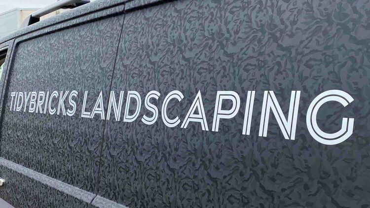Grey aesthetic vehicle wrap design for business branding on a local tradesman company van.