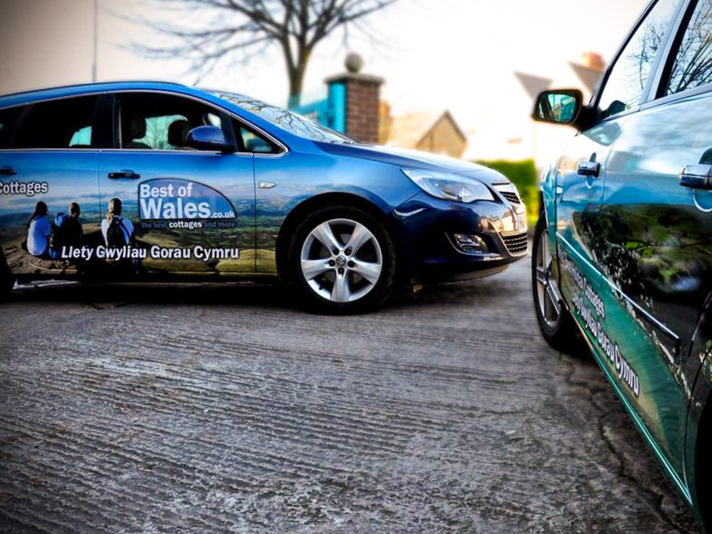 Fleet of Vauxhall Astra Sports Tourer cars with company branded livery for Best of Wales.
