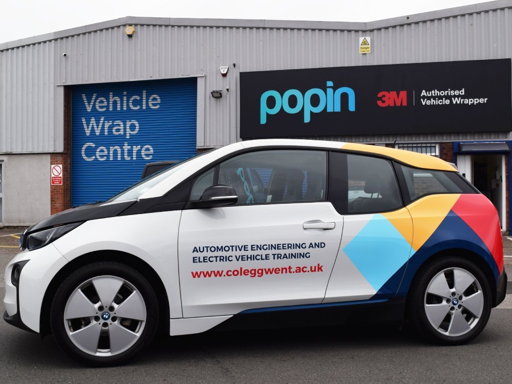 Branded company car wrap and graphics on BMW i3 outside Popin in Cardiff.