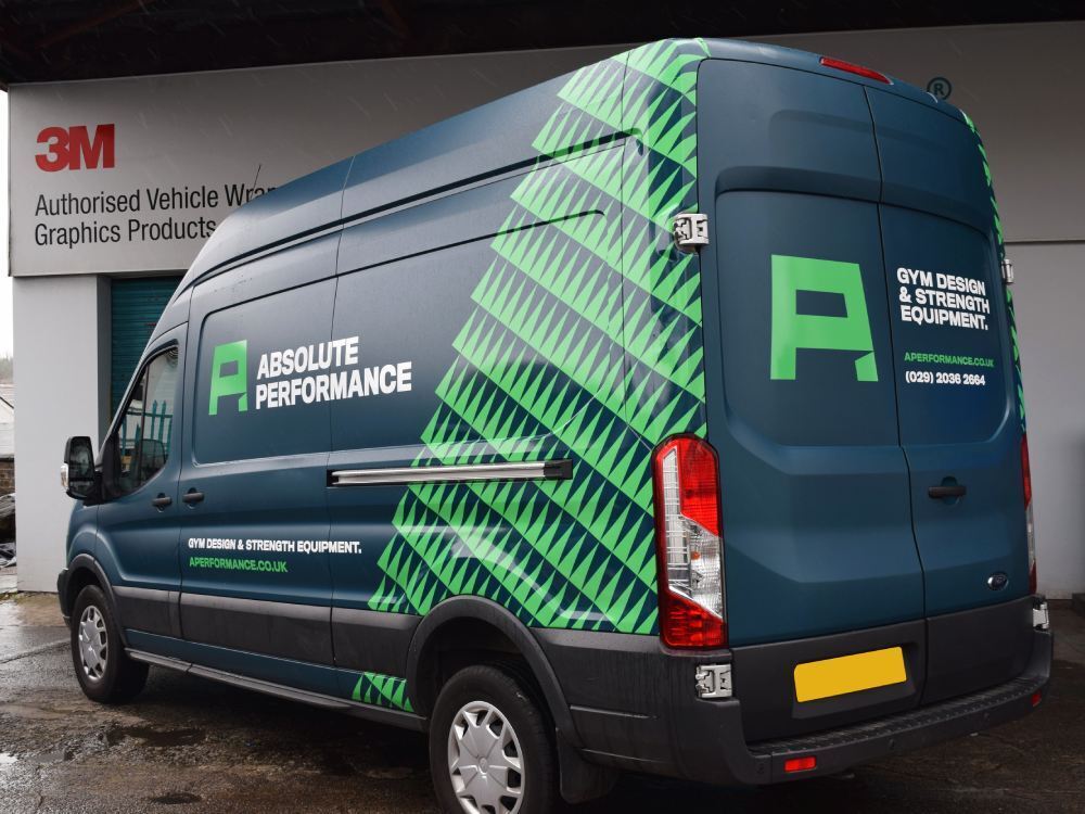 Blue and green vehicle wrap on a company Ford Transit van.