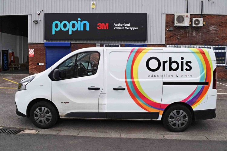 Colourful partial vehicle wrap on a white company Fiat Talento van outside Popin in Cardiff.