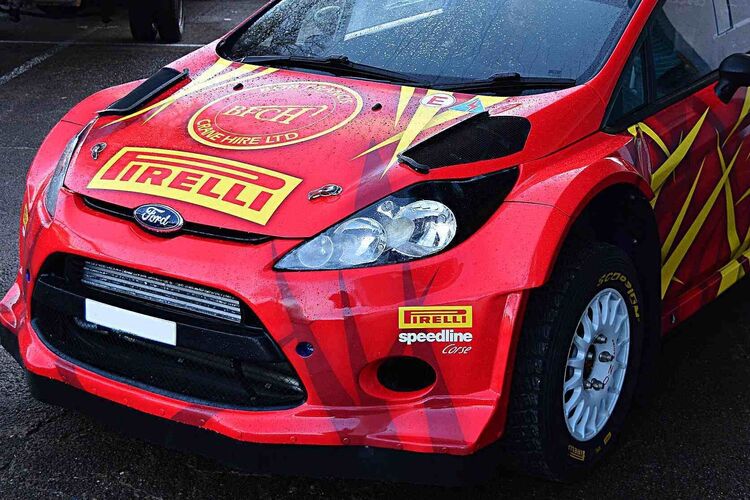 Red gloss vehicle vinyl wrap film on a race car.