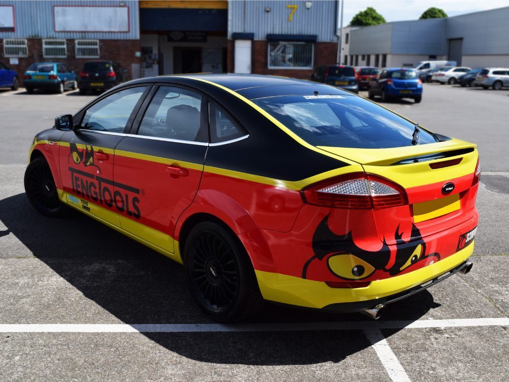 Vibrant motorsport livery and graphics on a Ford Mondeo race car