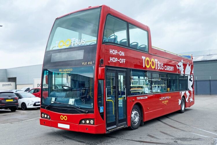 Ayats Bravo city open top bus with red livery and company branded vinyl graphics.