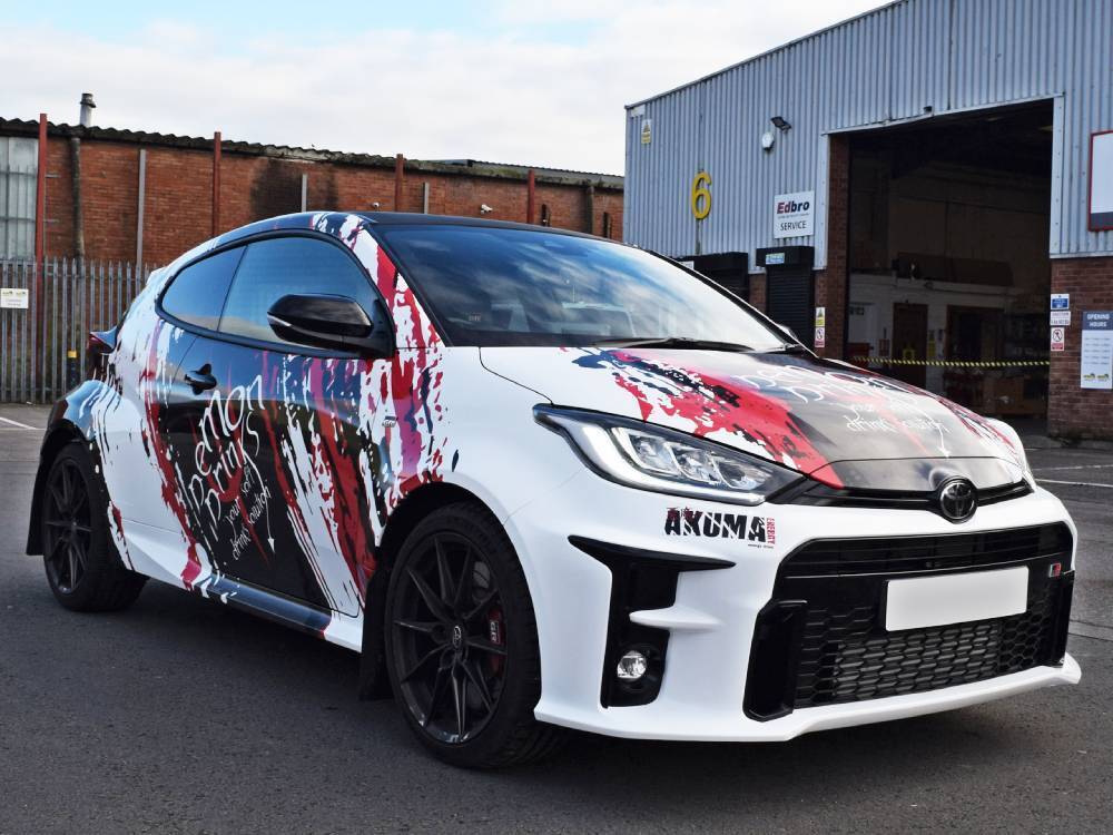 White Toyota Yaris GR company car with branded vehicle wrap and graphics.
