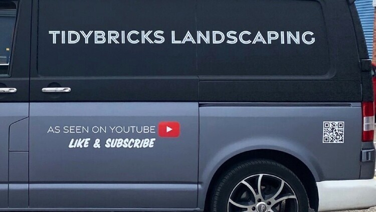Company van with vehicle wrap containing Youtube social media icon and QR code.