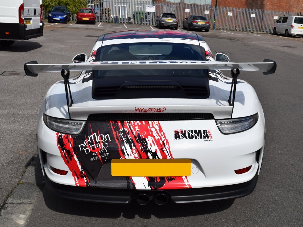 Motorsport graphics on rear end of a white Porsche GT3 RS sports car