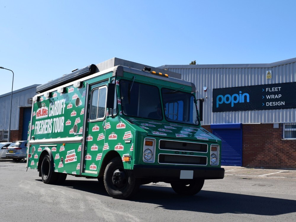GMC truck with green Papa Johns pizza vehicle livery outside Popin in Cardiff.