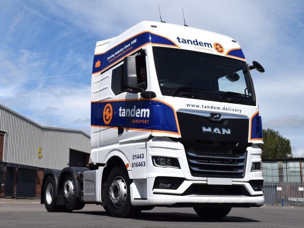 MAN lorry with vehicle wrap and vinyl graphics.