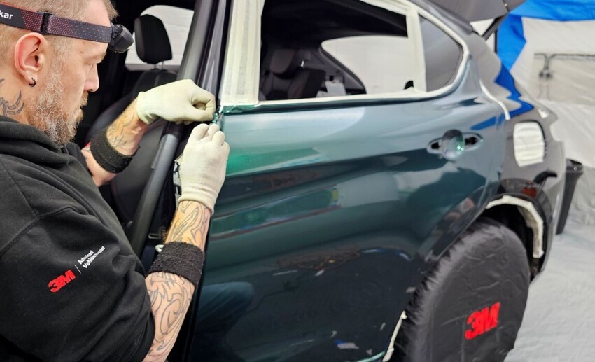 Installer preparing a vehicle for wrapping
