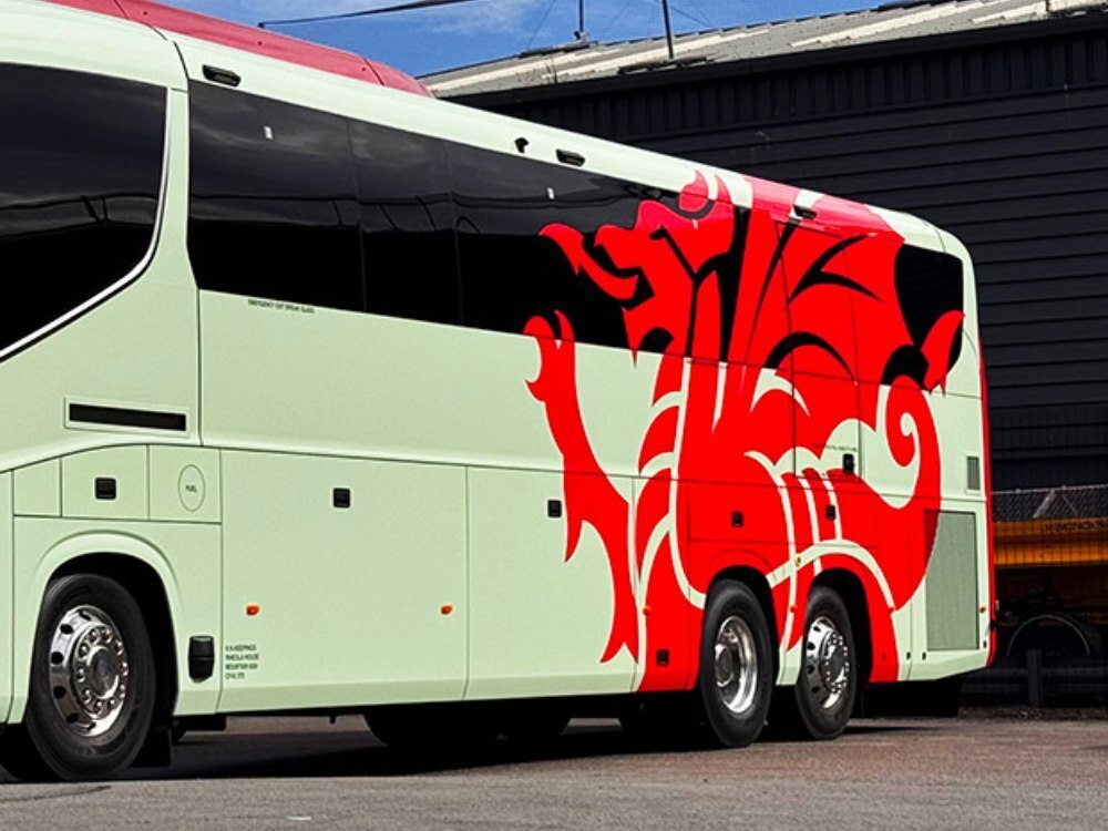 Red Welsh dragon design vinyl graphics for FAW Scania Irizar team coach.