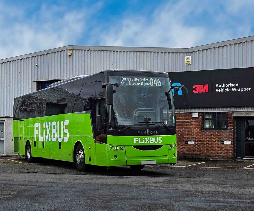 Vinyl graphics for vehicle business branding on a green Flixbus Van Hool coach